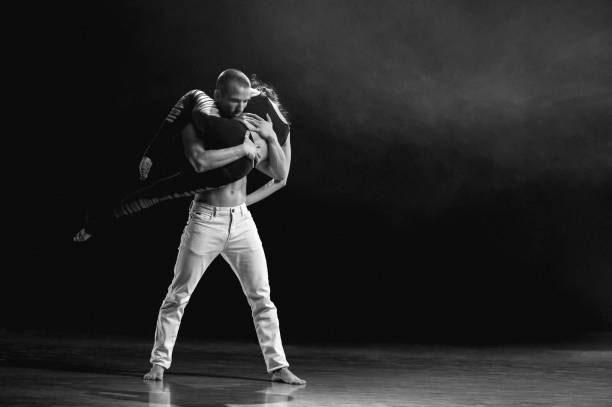 Artistically performance of two dancers on a stage.